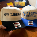 Two hats with political slogans held by a hand on a wooden surface.