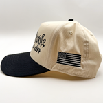 Side view of patriotic Two Tone Drunk America Hat that says we the people are pissed off and has an american flag embroidered on the side