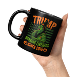 TRUMP_-_Scaring_Liberals_Since_2016_Blac_11oz_Black_LH_Model_Mockup.png