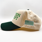Side view of an otto two tone green snapback with embroidered words that say taxation is theft and an american flag 