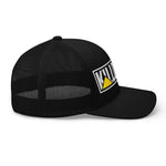 Black trucker hat with bold white and yellow logo, mesh back, flat brim — patriotic style gear